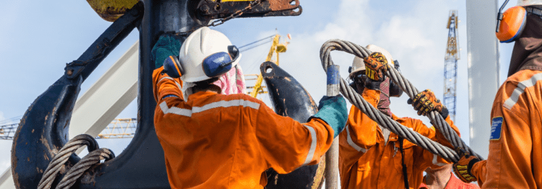 oil and gas workers getting equipment ready for drilling