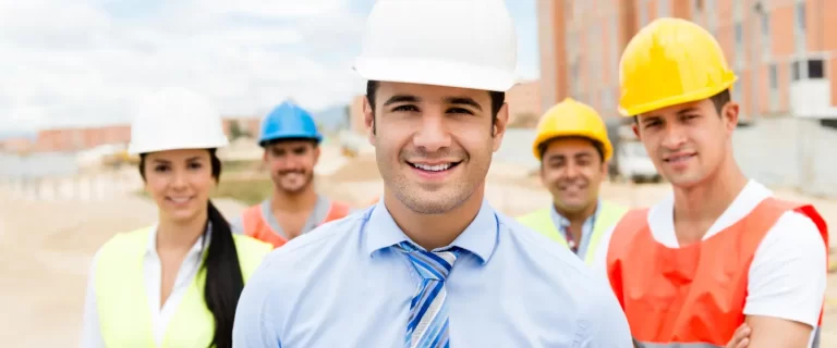 Group of male and female engineers smiling at the camera